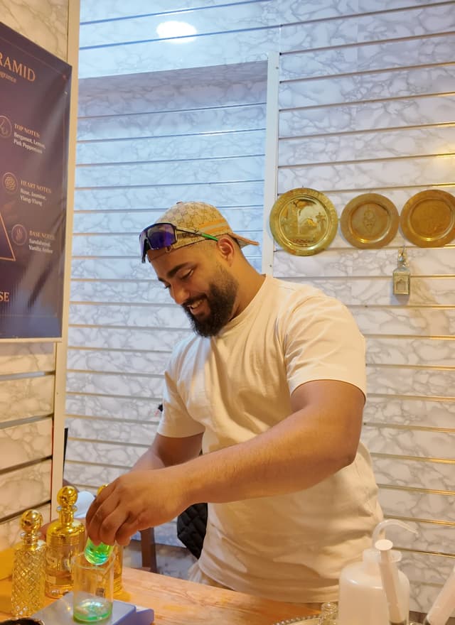 Warm master perfumer presenting a completed personalized perfume flacon