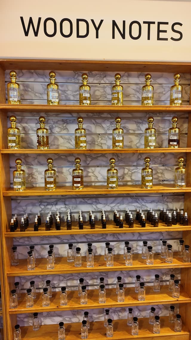 Woody notes section of The Perfume House shelves